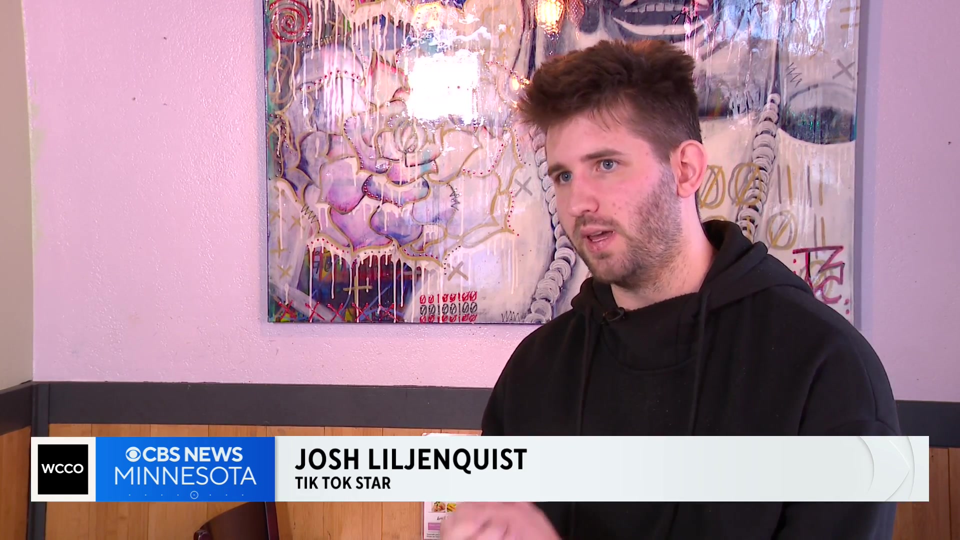 Josh Liljenquist speaking inside Lotus during a CBS News Minnesota report, with a lower third identifying him as a TikTok creator.