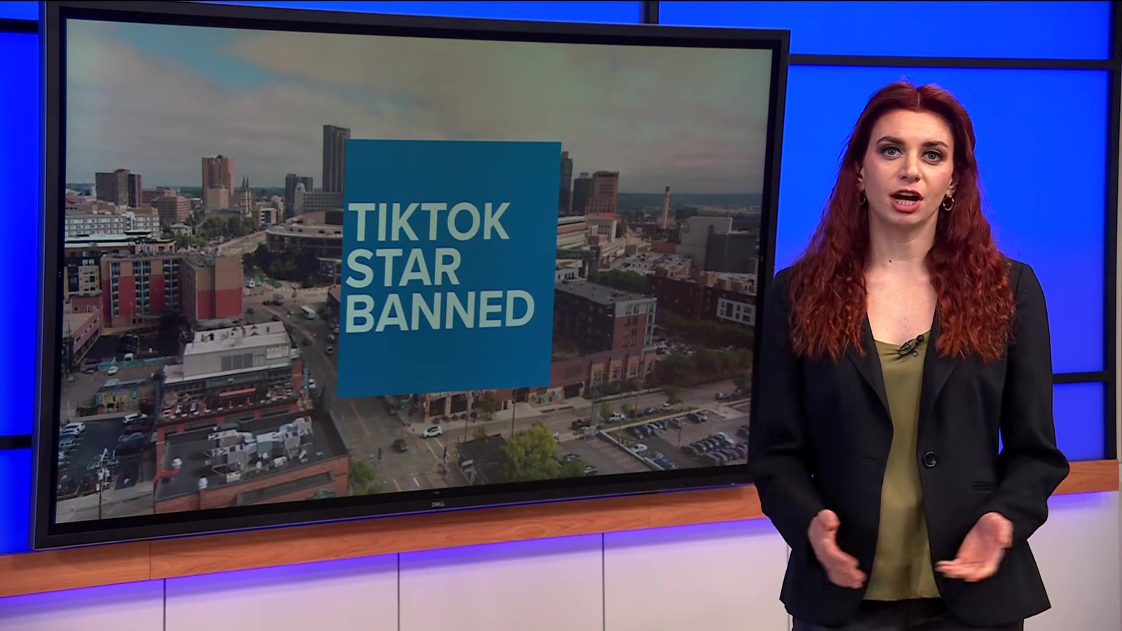 KARE 11 journalist Audrey Russo stands beside a studio display reading ‘TikTok Star Banned’ during coverage of Josh Liljenquist’s St. Paul parks restriction.
